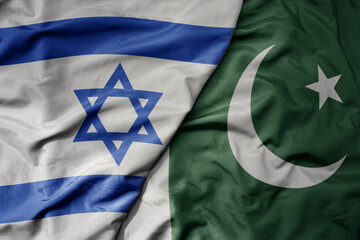 big waving realistic national colorful flag of israel and national flag of pakistan .