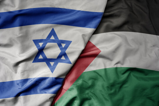 big waving realistic national colorful flag of israel and national flag of palestine .