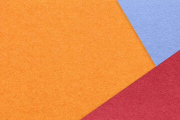 Texture of craft orange color paper background with red and blue border. Vintage abstract ginger cardboard.