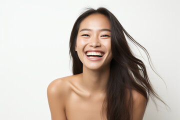 A close-up shot of a radiant young Asian woman, smiling with impeccable teeth. Designed for a dental promotion. With a white background. Crafted following the rule of thirds.
Generative AI.
