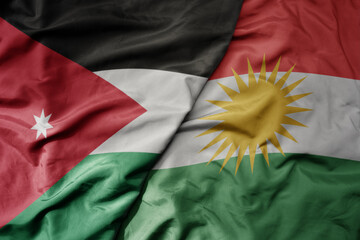 big waving realistic national colorful flag of jordan and national flag of kurdistan .