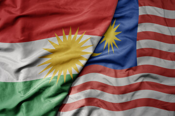 big waving realistic national colorful flag of kurdistan and national flag of malaysia .
