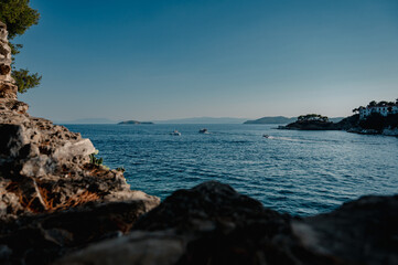 Evening view of the sea with small islands and boats on the coast of the Mediterranean sea, Greece, Skiathos