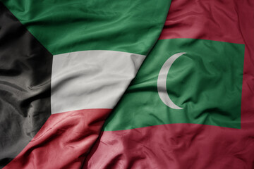 big waving realistic national colorful flag of kuwait and national flag of maldives .