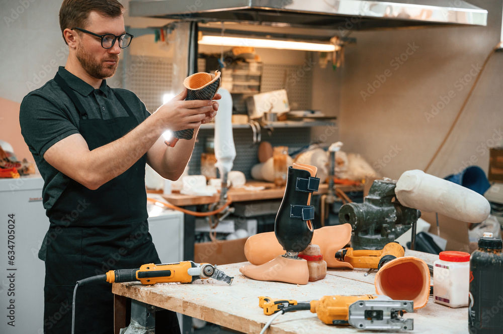 Wall mural with drill. technician working with prosthesis in modern laboratory