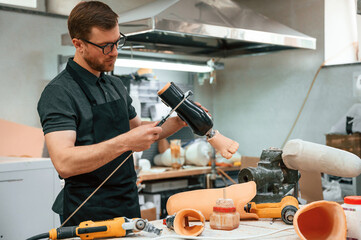 Measures the diameter of the prosthesis. Technician working in modern laboratory