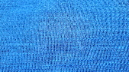   Blue linen fabric with plain weave. The texture of the fabric. Summer costume fabric.