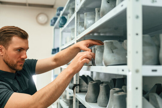Raw shoe parts for the prosthesis. Man is choosing size