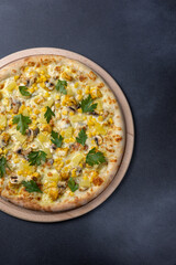 Italian cuisine. Delicious pizza on a dark background