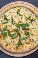 Italian cuisine. Delicious pizza on a dark background