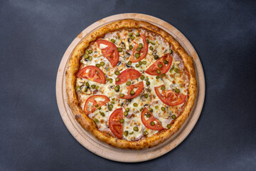 Italian cuisine. Delicious pizza on a dark background
