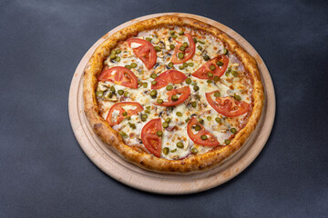 Italian cuisine. Delicious pizza on a dark background