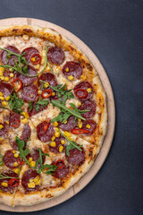 Italian cuisine. Delicious pizza on a dark background