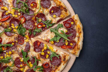 Italian cuisine. Delicious pizza on a dark background