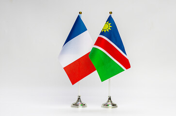 The national flags of France and Namibia on a light background.