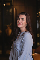 Smiling young woman in living room