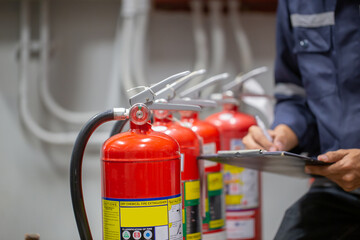 Engineer Professional are Checking A Fire Extinguisher Using Clipboard or checking Industrial fire...
