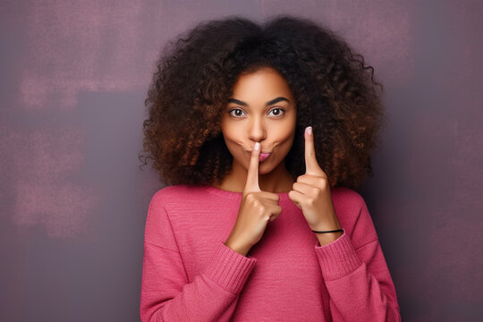 Hipster teen gen z black american girl showing shh sign finger gesture asking to keep secret, be hush silent or privacy silence on urban wall background. Teenage problem secrecy concept. 