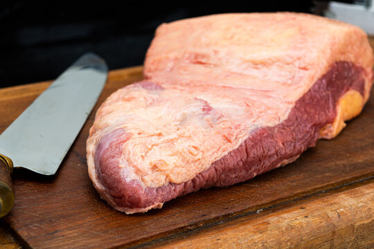 ponta de peito or brisket, raw for barbecue over wooden table