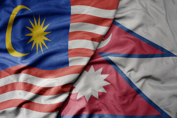 big waving realistic national colorful flag of malaysia and national flag of nepal .