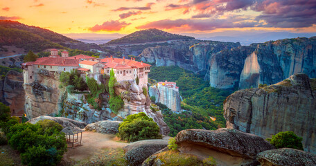 Panoramic view of Meteora. Greece, Meteora Monasteries. Panoramic view of the Holy Monastery of Varlaam, located on the edge of a high cliff. Beautiful sunrise. - obrazy, fototapety, plakaty