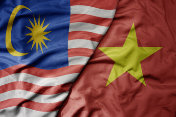 big waving realistic national colorful flag of malaysia and national flag of vietnam .