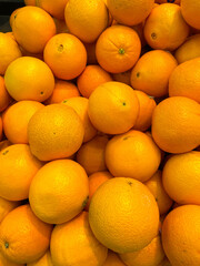 A pile of yellow oranges, close-up,