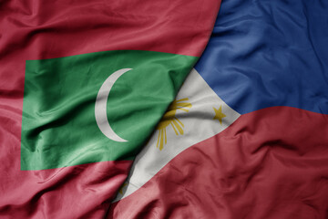 big waving realistic national colorful flag of maldives and national flag of philippines .