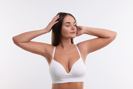 Portrait of young woman with beautiful breast on white background