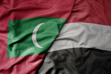 big waving realistic national colorful flag of maldives and national flag of yemen .