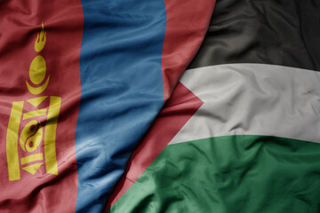 big waving realistic national colorful flag of mongolia and national flag of palestine .