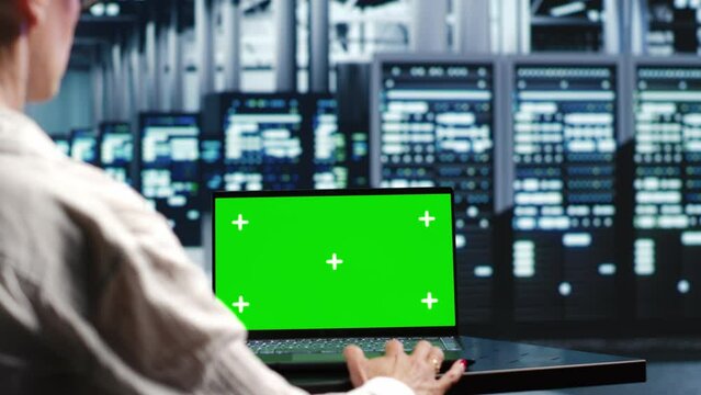 Old professional in servers workplace housing high end processors capable of quickly and efficiently performing complex computations and data analysis, using mockup laptop to adjust electronics