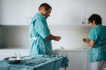 Male and female surgeons getting ready for surgery in hospital