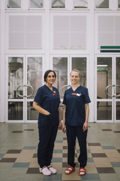 Portrait of smiling healthcare female staff standing in front of hospital