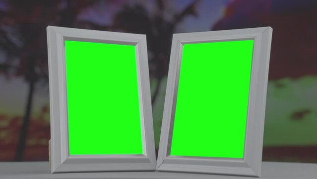 Two photo frames with green chroma key against seacoast background with palm trees at sunset