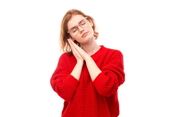 Studio portrait young redhead woman put palms under head pretending to sleep isolated on white background