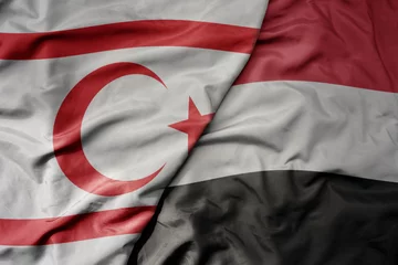 Foto op Canvas big waving realistic national colorful flag of northern cyprus and national flag of yemen . © luzitanija