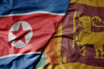big waving realistic national colorful flag of north korea and national flag of sri lanka .