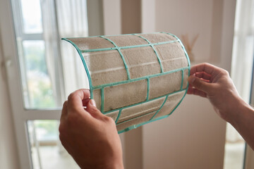 Dirty air conditioner filter need cleaning. Air conditioner service, repair and clean equipment.