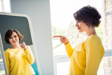 Photo of charming pretty lady doing every morning motivation for self care pointing finger mirror...