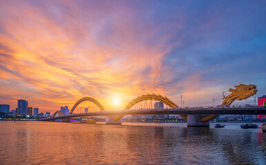 Dragon Bridge and traffic in Da Nang Vietnam. And beautiful sunset sky.