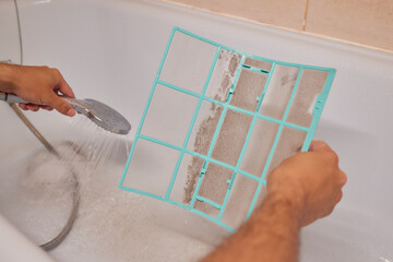 Washing air-conditioner filter with water