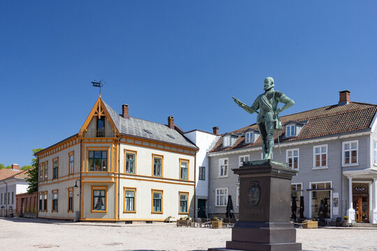 Happy walking in old Fredrikstad on a great warm summer day, with many old buildings, Norway	