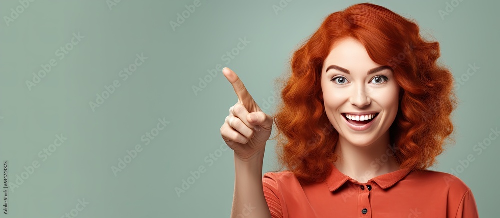 Aufkleber happy red haired caucasian woman pointing up and to the side indicating object in space