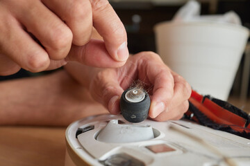 robot vacuum cleaner brush clogged with hair and dust