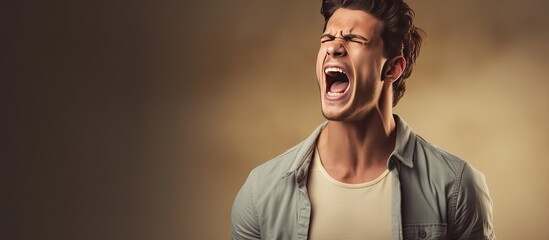 A furious young man gesturing and yelling loudly in a blank area