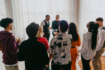 Smiling businesswoman addressing colleagues during event at convention center