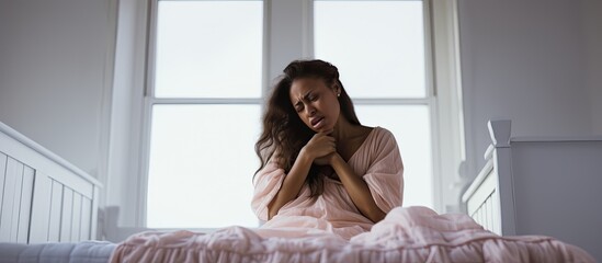 Fototapeta premium Emotional pregnant woman facing depression experiencing hormonal changes distressed and covering face in white bedroom