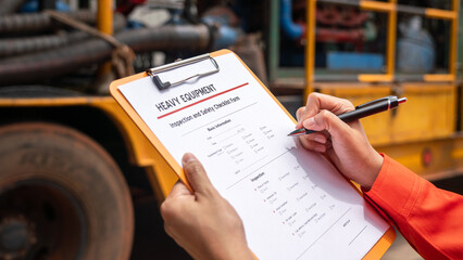 Action of a mechnical engineer is using a pen to mark at need repair on the heavy machine inspection form. Industrial service working concept. Selective focus.	
 - obrazy, fototapety, plakaty