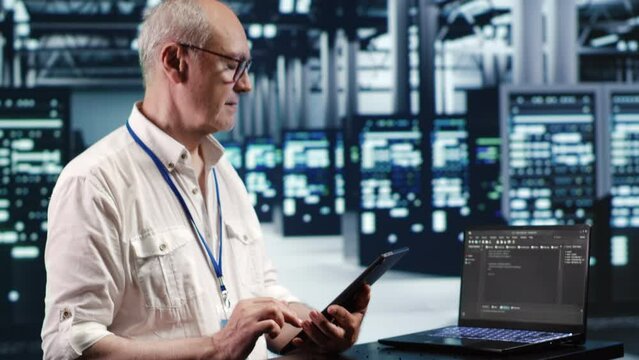 IT solutions expert in data center environment, solving tasks on tablet while running scripts on laptop terminal. Skilled specialist amidst servers, accessing databases and manipulating lines of code